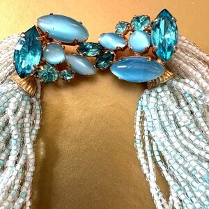 Vintage statement necklace is beaded with jewel tones of ocean blues.